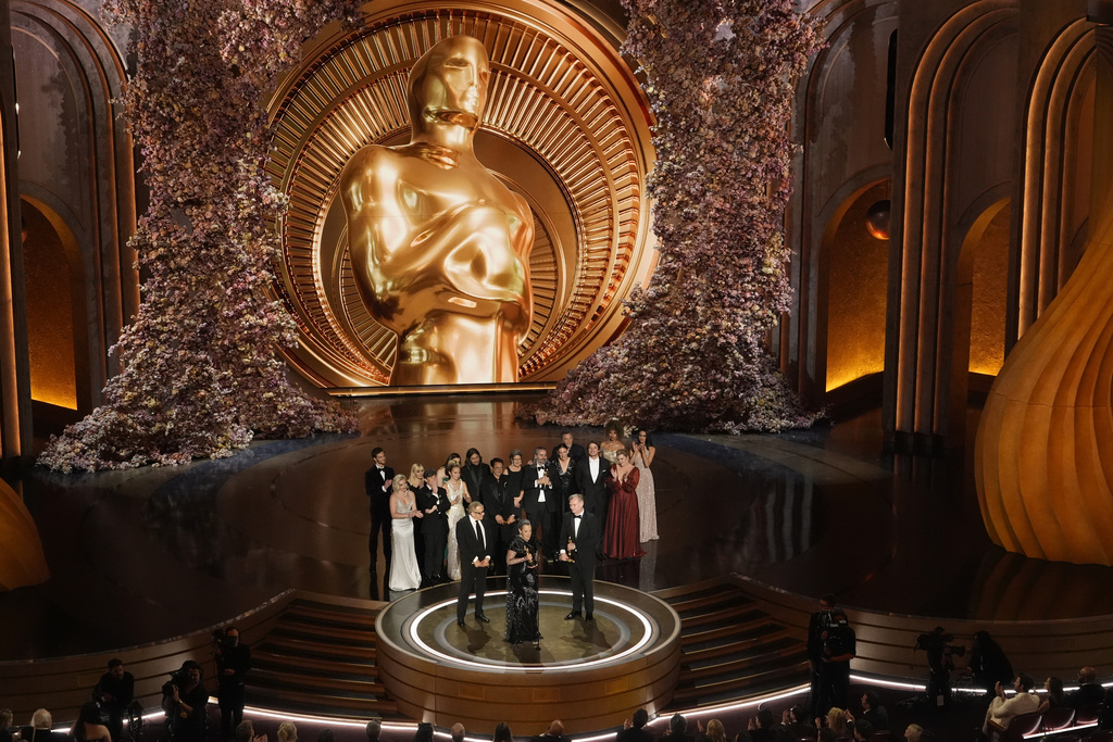 The cast of the movie Oppenheimer accepts an award at the Oscars.