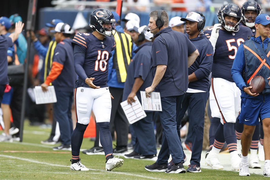 Caleb Williams and Shae Waldron talk after a play in an NFL game.