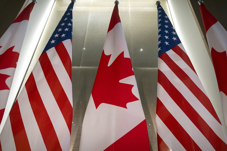 A picture of the Canadian and the American flags.