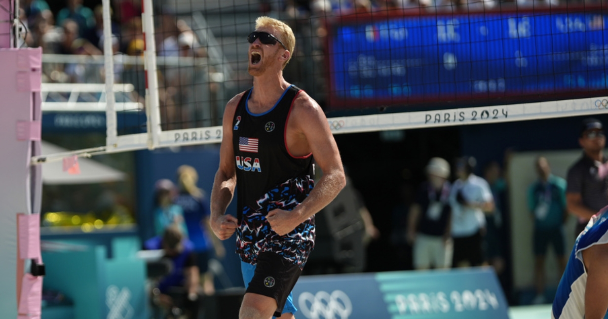 Chase Budinger celebrates a block against France in a beach volleyball match at the 2024 Summer Olympics.