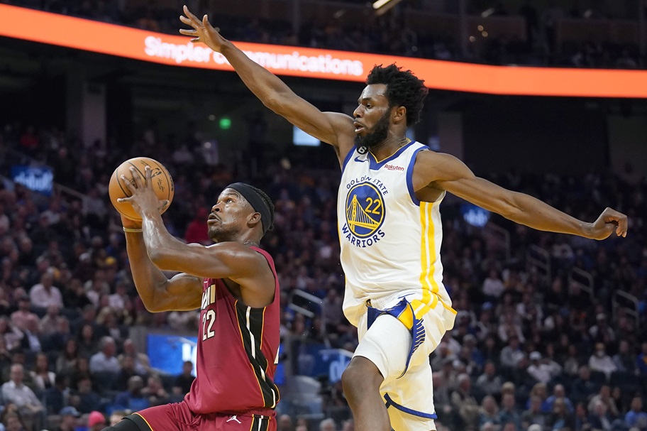 Andrew Wiggins tries to block a shot by Jimmy Butler