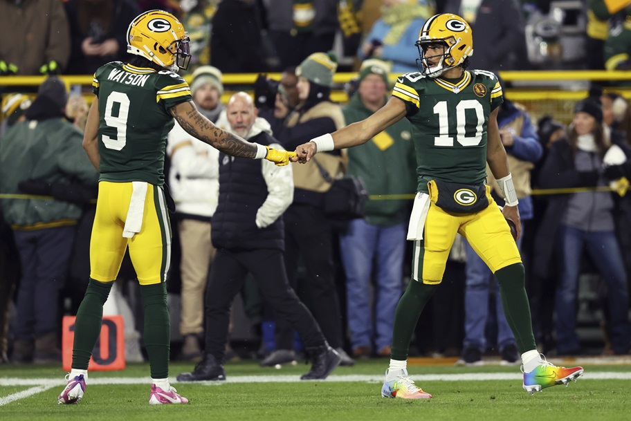 Jordan Love and Christian Watson of the Green Bay Packers get ready for an NFL game.