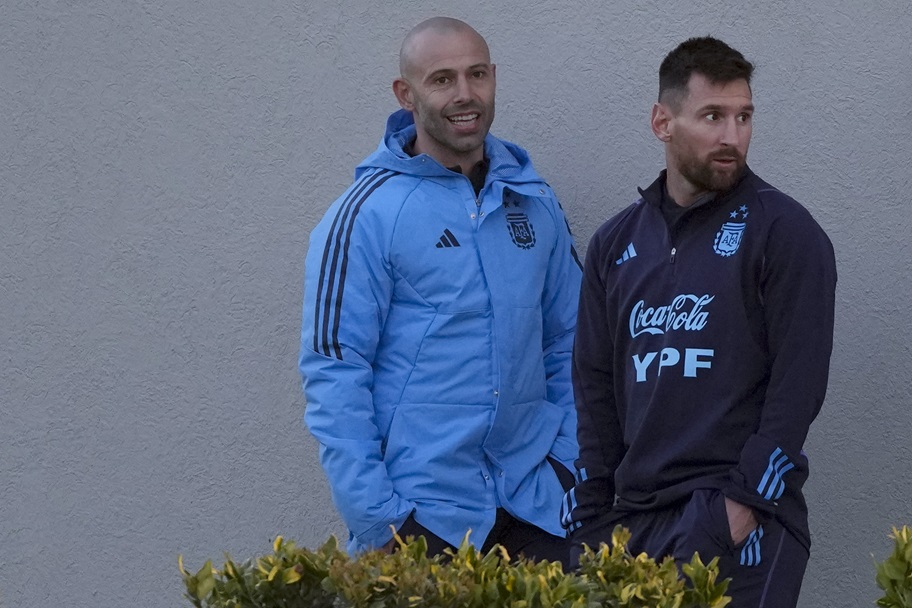 Javier Mascherano and Lionel Messi talk before an Argentina training session.